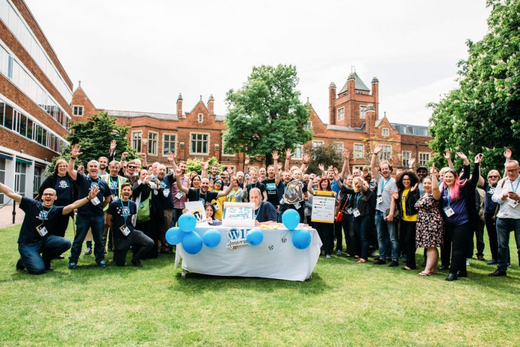 Group picture in the garden of some of the participants at WCBELFAST 2018 with a special WordPress 15 years cake