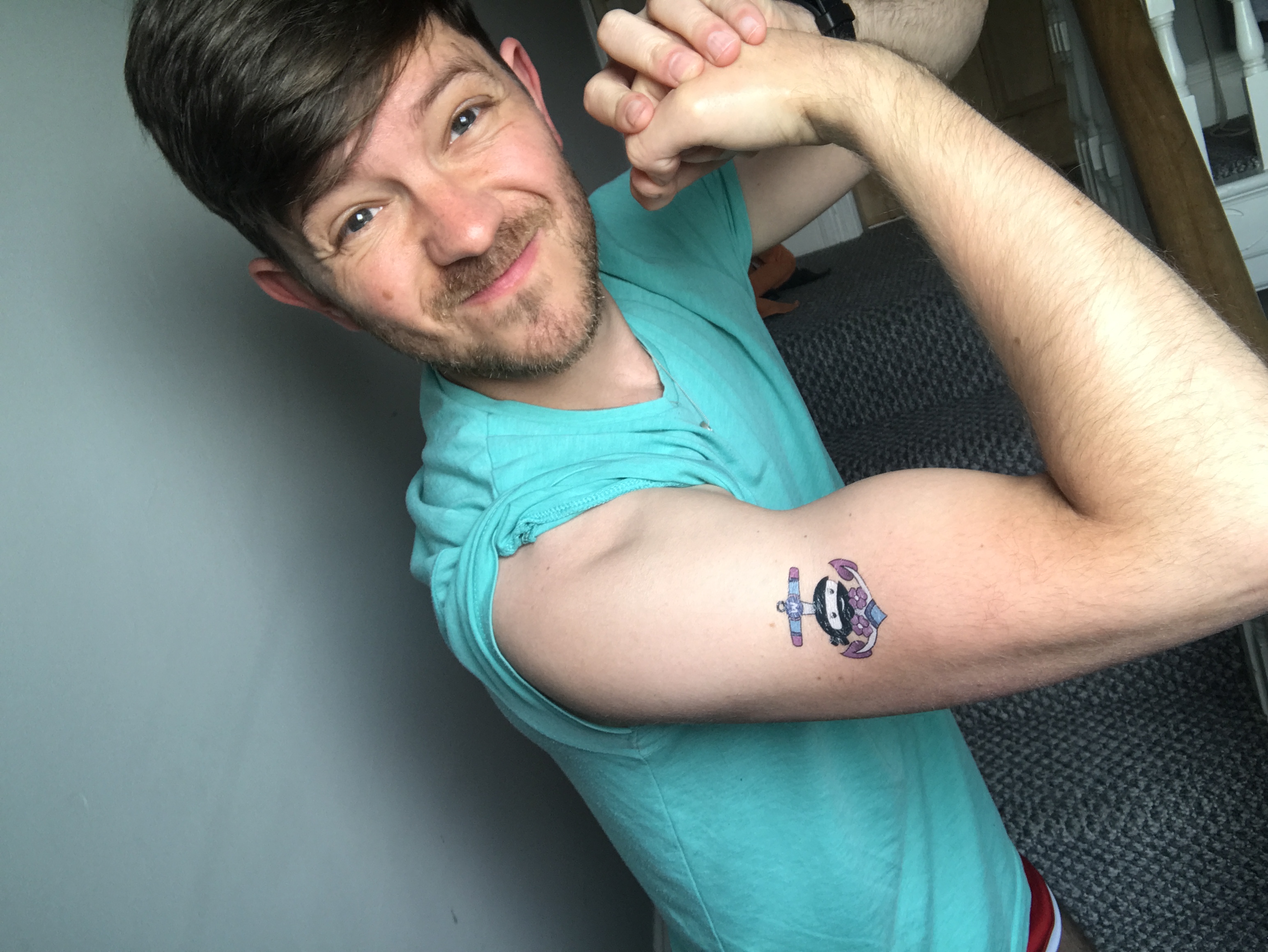 Neil Hainsworth showing off WooCommerce temporary tattoos on his arm